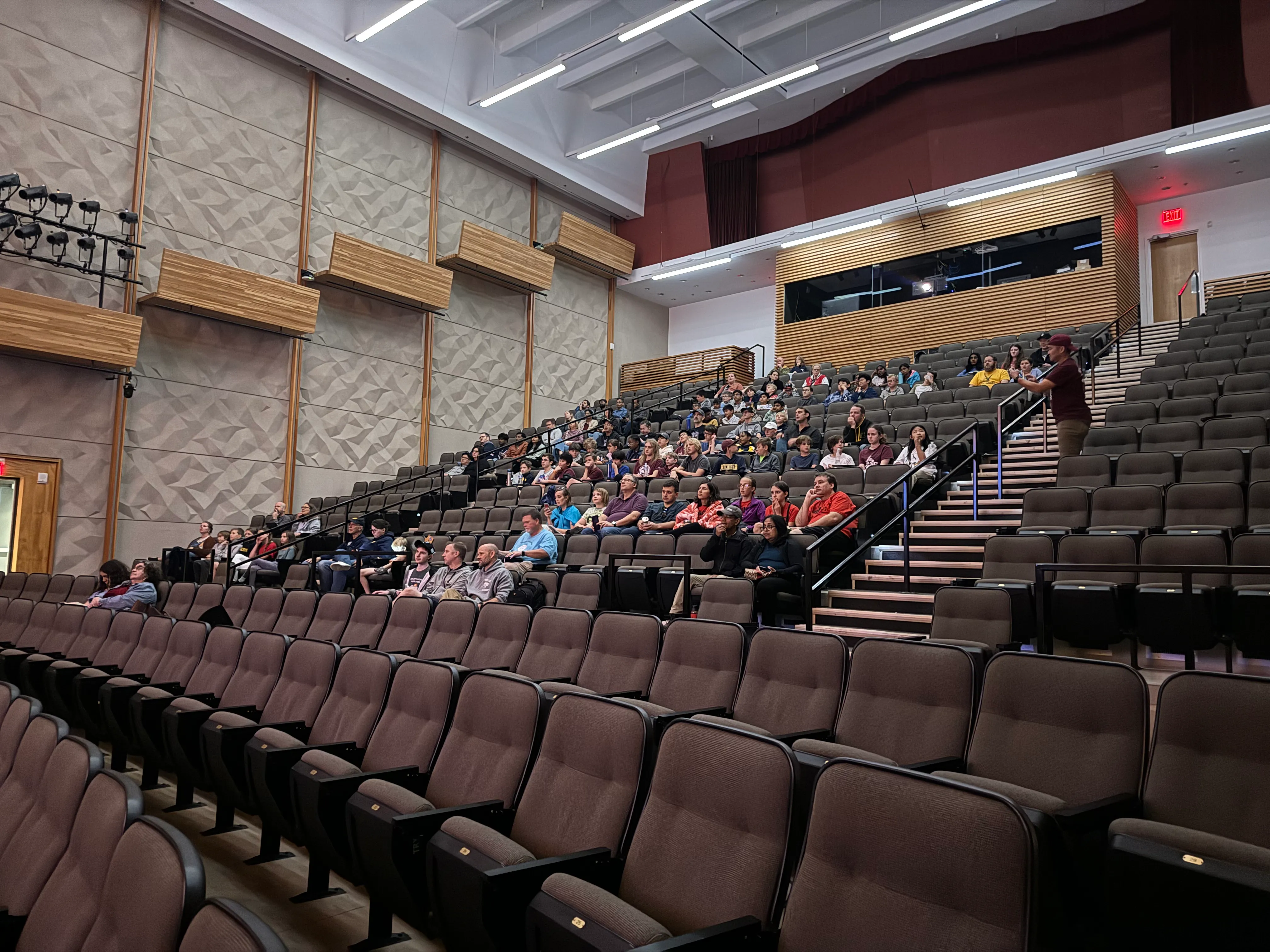 FTC team members watch a presentation attentively in an auditorium